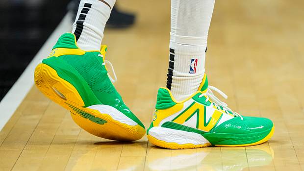 Atlanta Hawks guard Dejounte Murray's green and yellow New Balance shoes.