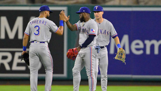 Texas Rangers center fielder Leody Taveras, left, celebrates a win with right fielder Adolis Garcia, center, and left fielder Evan Carter, right, in September.
