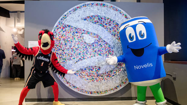 Hawks and Novelis mascots posing for a picture.