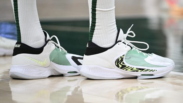 View of white and green Nike Zoom Freak shoes.