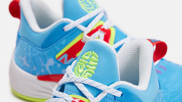 Detailed look at blue, green, and red New Balance shoes.