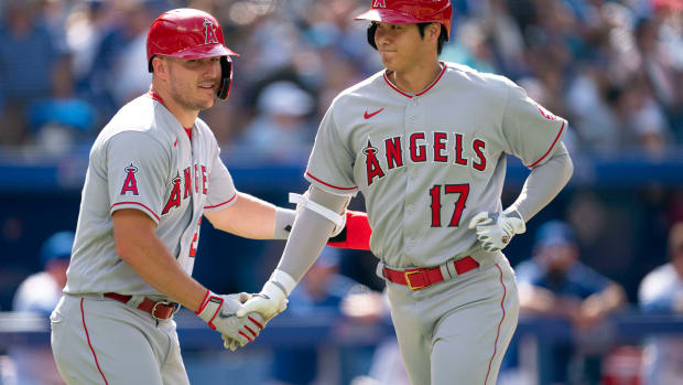 Mike Trout congratulates Shohei Ohtani after he hit a home run.