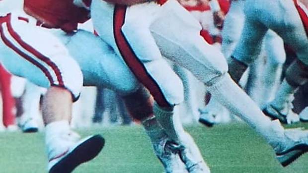 Danny Noonan wraps up Oklahoma State quarterback Rusty Hilger.