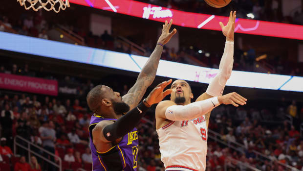 Houston Rockets forward Dillon Brooks (9) puts up a hook shot over Los Angeles Lakers forward LeBron James (23)