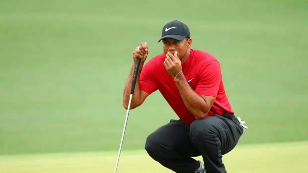 Tiger Woods lines up a putt during the final round of The Masters golf tournament.