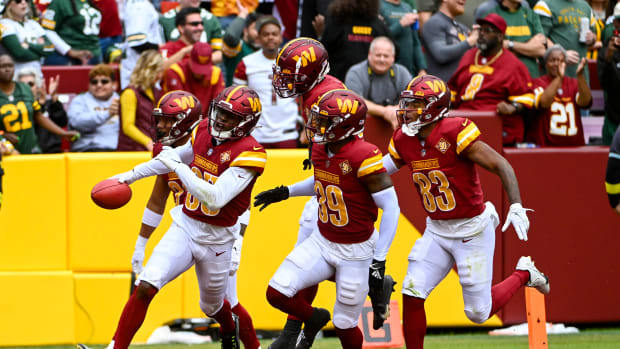 Percy Butler (35) of the Washington Commanders celebrates with teammates following the recovery of a muffed punt against the Green Bay Packers.