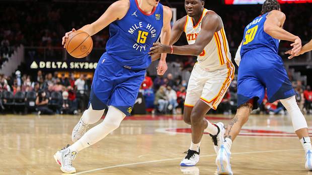 Hawks center Clint Capela defends Nuggets center Nikola Jokic.