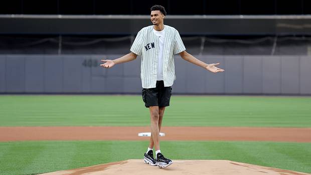 Victor Wembanyama reacts after throwing out the first pitch before a New York Yankees game.