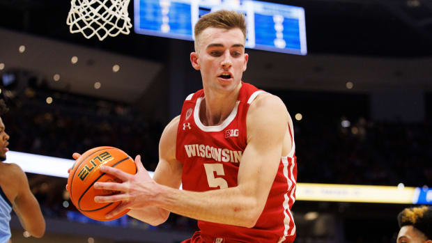 Wisconsin forward Tyler Wahl grabbing the basketball against Marquette.