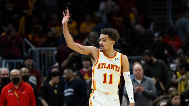 Trae Young waves to fans after a win against the Cleveland Cavaliers.