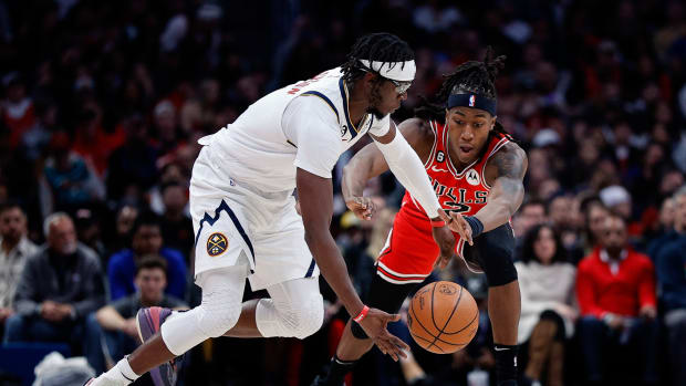 Mar 8, 2023; Denver, Colorado, USA; Denver Nuggets guard Reggie Jackson (7) controls the ball as Chicago Bulls guard Ayo Dosunmu (12) defends