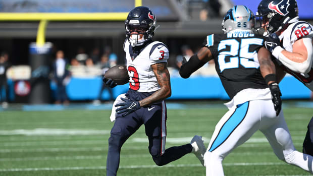Houston Texans wide receiver Tank Dell (3) runs as Carolina Panthers safety Xavier Woods (25) defends in the first quarter at Bank of America Stadium.