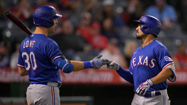 Sep 27, 2023; Anaheim, California, USA; Texas Rangers second baseman Marcus Semien (2) is congratulated by first baseman Nathaniel Lowe (30) after hitting a solo run home run in the ninth inning against the Los Angeles Angels at Angel Stadium. Mandatory Credit: Jayne Kamin-Oncea-USA TODAY Sports  