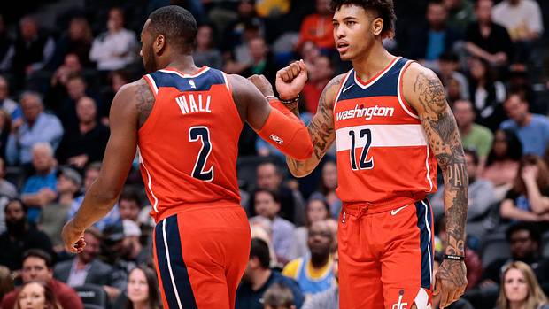 Washington Wizards guard John Wall (2) and forward Kelly Oubre Jr. (12) react after a play in the fourth quarter against the Denver Nuggets at the Pepsi Center.