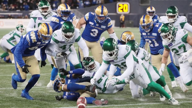 Dec 5, 2021; Winnipeg, Manitoba, CAN; Saskatchewan Roughriders wide receiver Mitchell Picton (81) fumbles the ball as Saskatchewan Roughriders running back Jamal Morrow (25) recovers it during the Canadian football League Western Conference Final game against the Winnipeg Blue Bombers at IG Field. Mandatory Credit: Bruce Fedyck-USA TODAY Sports  