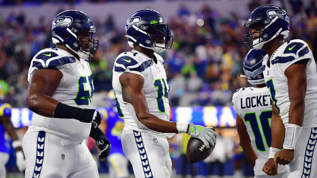Seattle Seahawks wide receiver DK Metcalf (14) celebrates his touchdown scored against the Los Angeles Rams with guard Damien Lewis (68) and quarterback Geno Smith (7) during the second half at SoFi Stadium