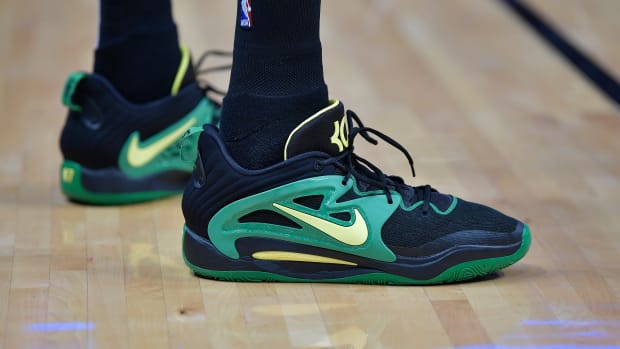 View of Kevin Durant's black and green Nike shoes.