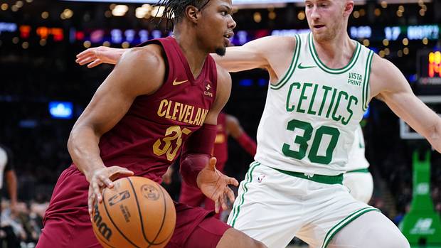 Dec 12, 2023; Boston, Massachusetts, USA; Cleveland Cavaliers forward Isaac Okoro (35) drives the ball against Boston Celtics forward Sam Hauser (30) in the first quarter at TD Garden. Mandatory Credit: David Butler II-USA TODAY Sports