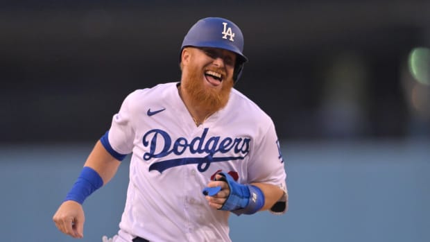 Justin Turner smiles after hitting a home run.