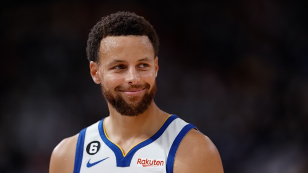 Stephen Curry smiles after a play.