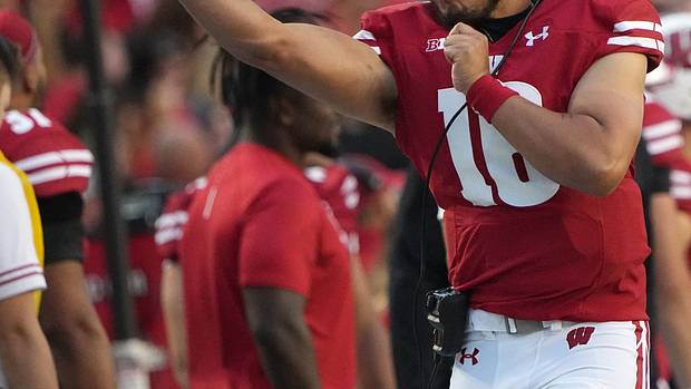Wisconsin freshman quarterback Myles Burkett warming up on the sidelines.