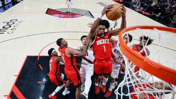 Rockets' Amen Thompson (1) comes down with a rebound next to Portland Trail Blazers forward Rayan Rupert (72) during the second half at Moda Center.