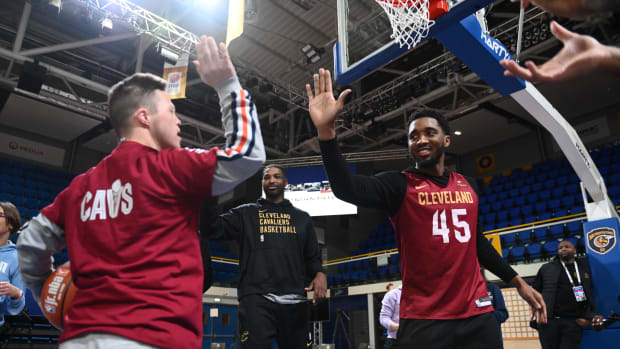 Cleveland Cavaliers guard Donovan Mitchell high-fives a participant at a Jr. NBA Camp in Paris, France.