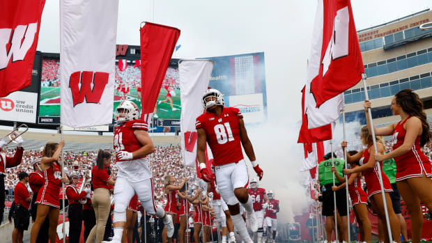 The Wisconsin Badgers running out of the tunnel before playing Washington State.