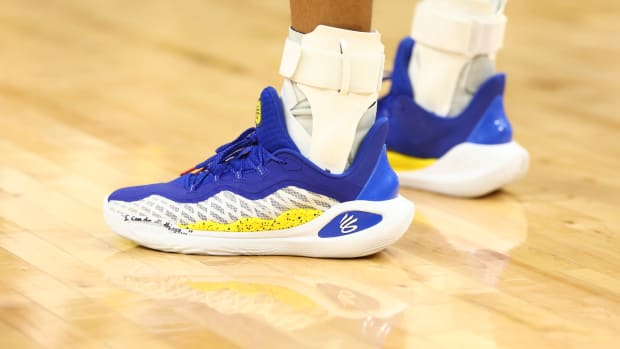 Golden State Warriors guard Stephen Curry's blue and white Under Armour shoes.