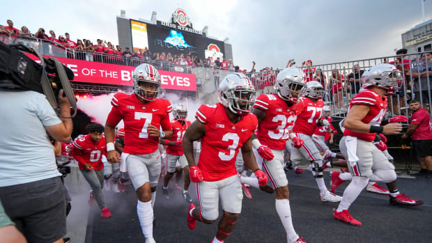Ohio State players run out of the tunnel ahead of their game versus Toledo