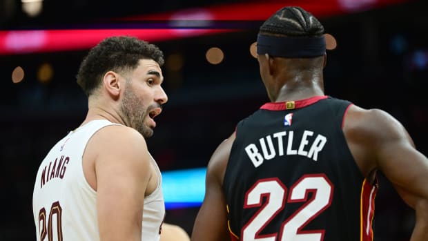 Nov 22, 2023; Cleveland, Ohio, USA; Cleveland Cavaliers forward Georges Niang (20) talks to Miami Heat forward Jimmy Butler (22) during the second half at Rocket Mortgage FieldHouse.