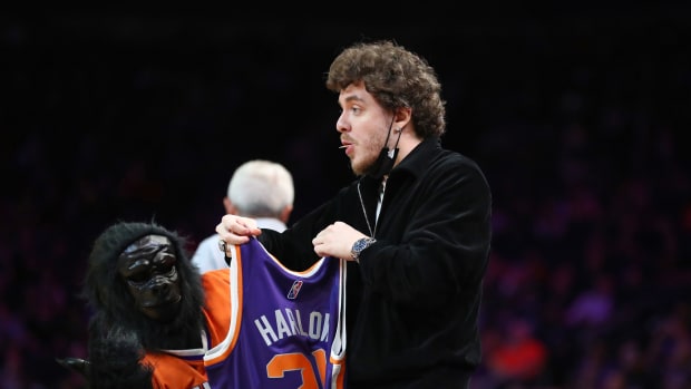 Rapper/recording artist Jack Harlow receives a Phoenix Suns jersey from mascot The Gorilla against the New Orleans Pelicans in the first half at Footprint Center.
