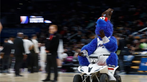 Washington Wizards mascot G-Wiz drives a motorized scooter around the court during a timeout against the Miami Heat in the third quarter at Capital One Arena