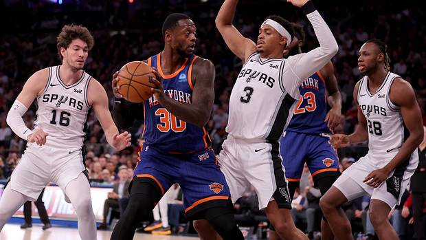 New York Knicks forward Julius Randle (30) controls the ball against San Antonio Spurs forwards Cedi Osman (16) and Keldon Johnson (3) and center Charles Bassey (28) during the third quarter at Madison Square Garden.
