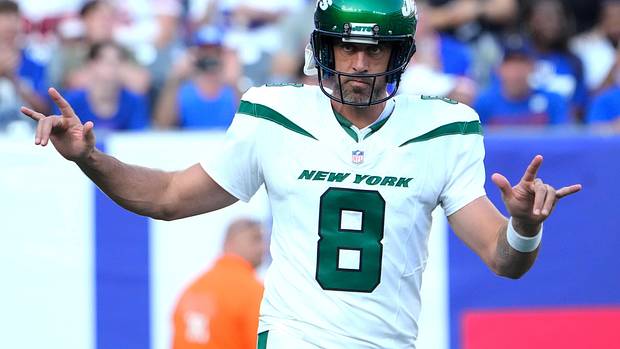 New York Jets quarterback Aaron Rodgers (8) greets the cheers of fans on his first appearance as a Jet against the Giants at MetLife Stadium.