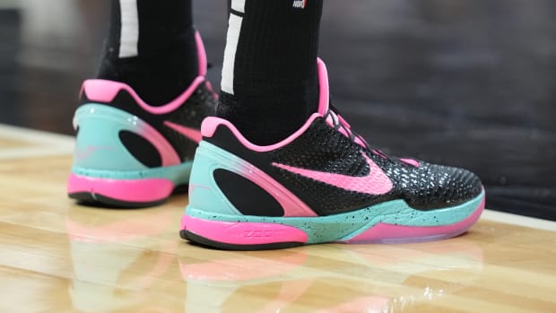 View of black, pink, and teal Nike Kobe shoes.