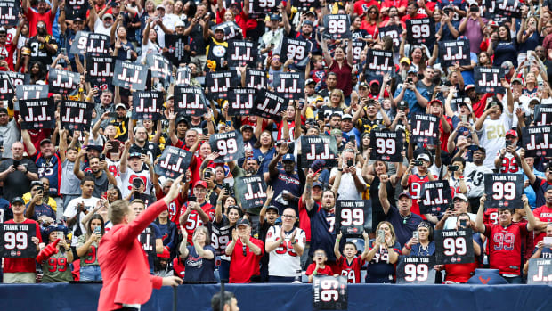 Texans player J.J. Watt waves while fans cheer after Watt is inducted into the Texans Ring of Honor during the game against the Pittsburgh Steelers at NRG Stadium.