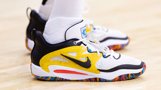View of Kevin Durant's white, black, and yellow Nike shoes.