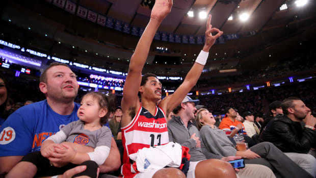 Washington Wizards guard Jordan Poole (13) reacts to a teammate's three point shot as he sits court side with fans during the third quarter against the New York Knicks at Madison Square Garden. Mandatory Credit: Brad Penner-USA TODAY Sports