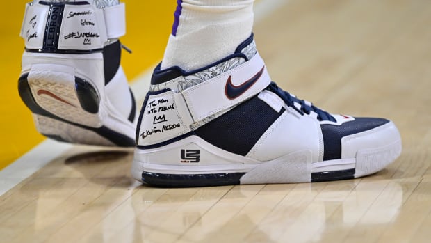 View of LeBron James' white and navy Nike shoes.