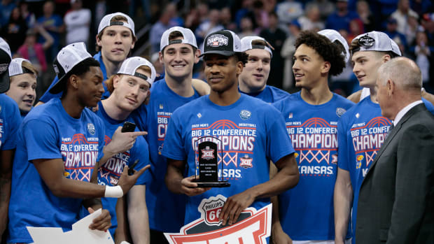 Mar 12, 2022; Kansas City, MO, USA; Kansas Jayhawks guard Ochai Agbaji (30) is presented the most outstanding player award after the game against the Texas Tech Red Raiders at T-Mobile Center. Mandatory Credit: William Purnell-USA TODAY Sports