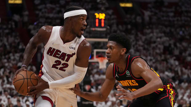 Apr 19, 2022; Miami, Florida, USA; Miami Heat forward Jimmy Butler (22) controls the ball around Atlanta Hawks forward De'Andre Hunter (12) during the first half in game two of the first round for the 2022 NBA playoffs at FTX Arena.