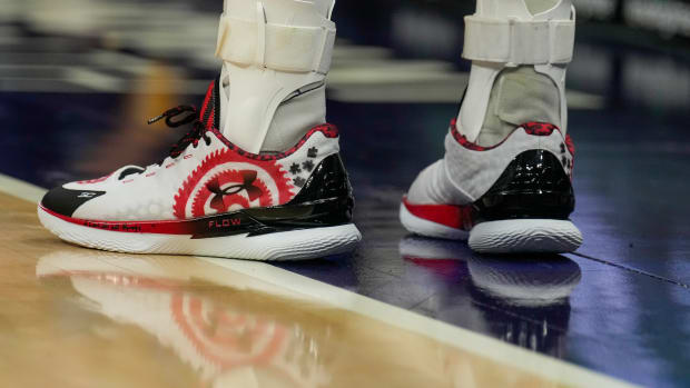 Stephen Curry's white, red, and black shoes.