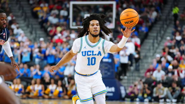 UCLA Bruins guard Tyger Campbell passes the ball.