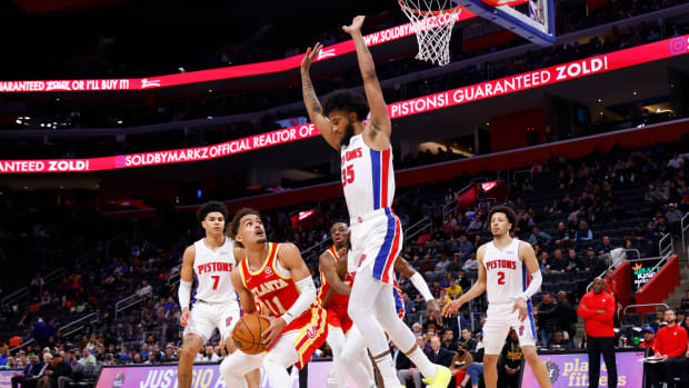 Mar 23, 2022; Detroit, Michigan, USA; Atlanta Hawks guard Trae Young (11) is defended by Detroit Pistons forward Marvin Bagley III (35) in the first half at Little Caesars Arena.