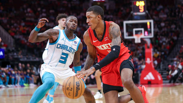 Rockets forward Jabari Smith Jr. attempts to drive with the ball around Charlotte Hornets guard Terry Rozier during the fourth quarter at Toyota Center.