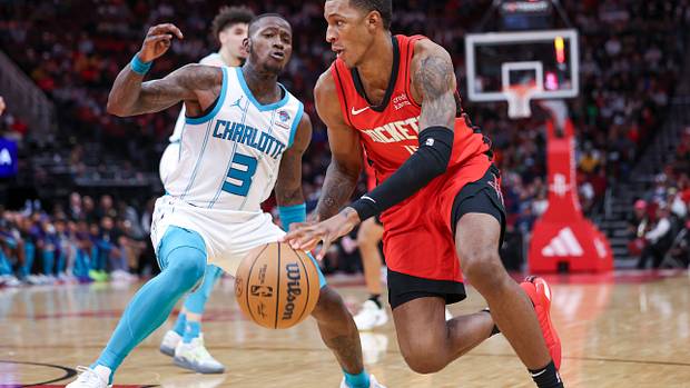 Rockets forward Jabari Smith Jr. attempts to drive with the ball around Charlotte Hornets guard Terry Rozier during the fourth quarter at Toyota Center.