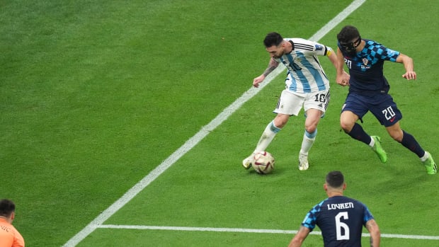 Argentina no.10 Lionel Messi pictured passing the ball to set up a goal against Croatia in a World Cup semi-final in December 2022
