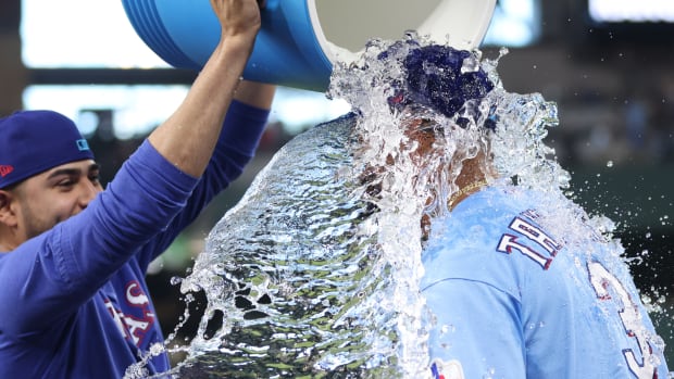 Jun 18, 2023; Arlington, Texas, USA; Texas Rangers center fielder Leody Taveras (3) has water poured on him by starting pitcher Martin Perez (54) after the game against the Toronto Blue Jays at Globe Life Field. Mandatory Credit: Tim Heitman-USA TODAY Sports