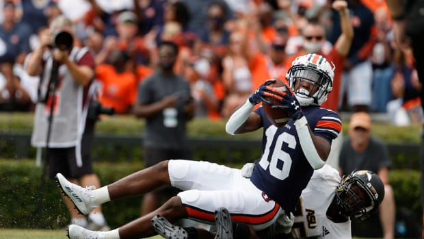 Sep 11, 2021; Auburn, Alabama, USA; Auburn Tigers wide receiver Malcolm Johnson Jr. (16) scores a touchdown as Alabama State Hornets defensive back Rodney Echols (25) defends during the third quarter at Jordan-Hare Stadium. Mandatory Credit: John Reed-USA TODAY Sports